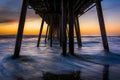 Waves under the fishing pier at sunset, in Imperial Beach, Calif