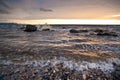 Waves wash ashore at sunset