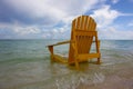 Waves wash over beach chair on Anegada Royalty Free Stock Photo