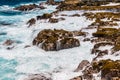 Waves Washing Over The Rugged Volcanic Shoreline