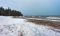 Snow on a frozen beach of the winter sea