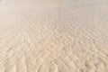 Waves on a yellow sandy bottom intersect with waves on the surface of water. The texture of sand and water. shallow, shoal, Royalty Free Stock Photo