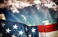 Waving american flag and sky in dark grunge style