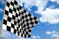 Waving checkered flag in front of a cloudy sky Royalty Free Stock Photo