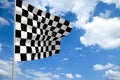 Waving checkered flag in front of a cloudy sky