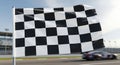 Waving checkered flag marks the end of a fast race Royalty Free Stock Photo