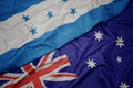 waving colorful flag of australia and national flag of honduras