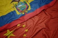 waving colorful flag of china and national flag of ecuador