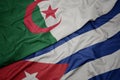 waving colorful flag of cuba and national flag of algeria