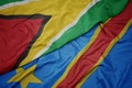 waving colorful flag of democratic republic of the congo and national flag of guyana Royalty Free Stock Photo