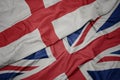 waving colorful flag of great britain and national flag of england