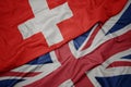 waving colorful flag of great britain and national flag of switzerland Royalty Free Stock Photo