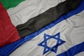 waving colorful flag of israel and national flag of united arab emirates