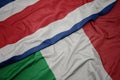 waving colorful flag of italy and national flag of costa rica