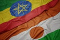 waving colorful flag of niger and national flag of ethiopia Royalty Free Stock Photo