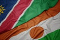 waving colorful flag of niger and national flag of namibia Royalty Free Stock Photo