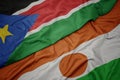 waving colorful flag of niger and national flag of south sudan Royalty Free Stock Photo