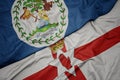 waving colorful flag of northern ireland and national flag of belize