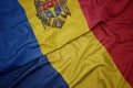 waving colorful flag of romania and national flag of moldova