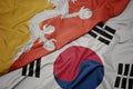 waving colorful flag of south korea and national flag of bhutan Royalty Free Stock Photo