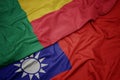 waving colorful flag of taiwan and national flag of benin