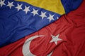 waving colorful flag of turkey and national flag of bosnia and herzegovina