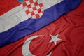 waving colorful flag of turkey and national flag of croatia