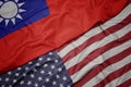 waving colorful flag of united states of america and national flag of taiwan