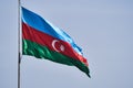 Waving colorful national flag of Azerbaijan on a blue sky background