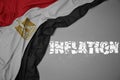 waving colorful national flag of egypt on a gray background with broken text inflation. 3d illustration Royalty Free Stock Photo