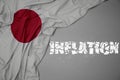 waving colorful national flag of japan on a gray background with broken text inflation. 3d illustration