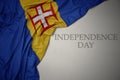 waving colorful national flag of madeira on a gray background with text independence day