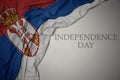 waving colorful national flag of serbia on a gray background with text independence day Royalty Free Stock Photo