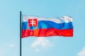 Waving colorful Slovakia flag on blue sky.