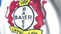 Waving flag with Bayer Leverkusen football club logo, close-up. Editorial 3D rendering