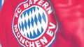 Waving flag with Bayern Munchen football team logo, close-up. Editorial 3D rendering