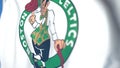 Waving flag with Boston Celtics team logo, close-up. Editorial 3D rendering