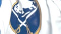 Waving flag with Buffalo Sabres NHL hockey team logo, close-up. Editorial 3D rendering