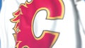 Waving flag with Calgary Flames NHL hockey team logo, close-up. Editorial 3D rendering