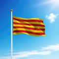 Waving flag of Catalonia is a community of Spain on flagpole