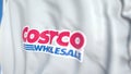 Waving flag with Costco logo, close-up. Editorial 3D rendering