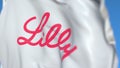 Flying flag with Eli Lilly And Company logo, close-up. Editorial 3D rendering