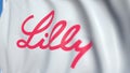 Flying flag with Eli Lilly And Company logo, close-up. Editorial loopable 3D animation