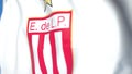 Flying flag with Estudiantes de Laplata football club logo, close-up. Editorial 3D rendering