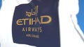 Waving flag with Etihad Airways logo, close-up. Editorial 3D rendering