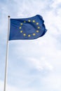 Waving flag of European Union in cloudy sky in mat Royalty Free Stock Photo