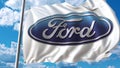 Waving flag with Ford logo against sky and clouds. Editorial 3D rendering