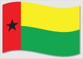 Waving flag of Guinea Bissau vector graphic. Waving Guinean flag illustration. Guinea Bissau country flag wavin in the wind is a