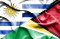 Waving flag of Guyana and Uruguay