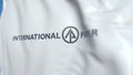 Waving flag with International Paper logo, close-up. Editorial 3D rendering
